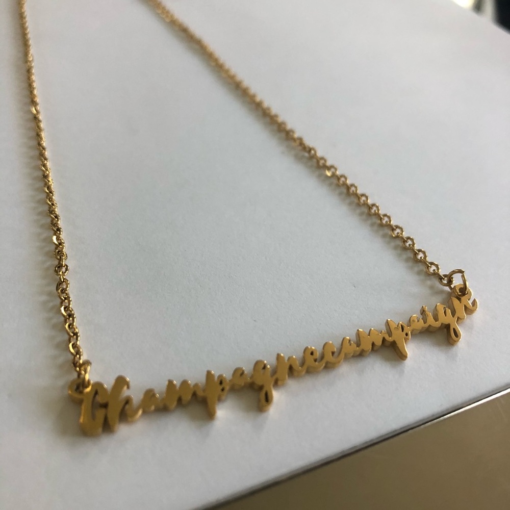 Gold necklace champagne campaign